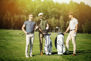 Group of golfers talking on the golf course - CBD for Golfers - Golf Gummies