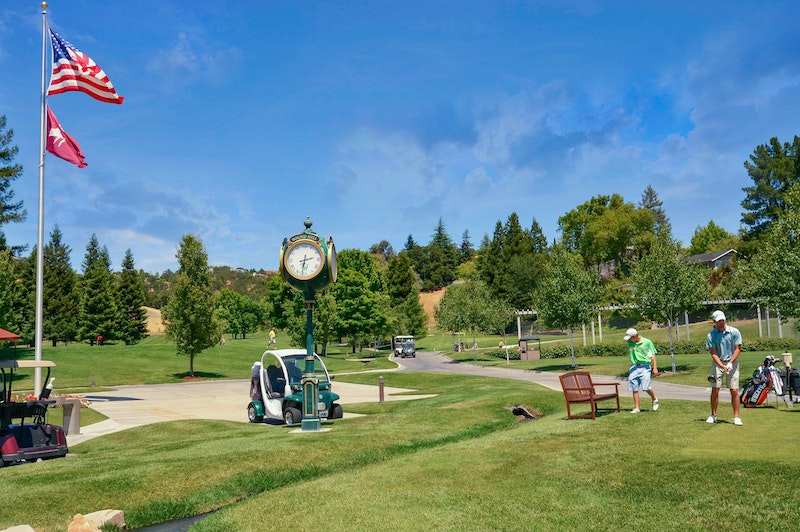 Golfers Teeing Off With Clock